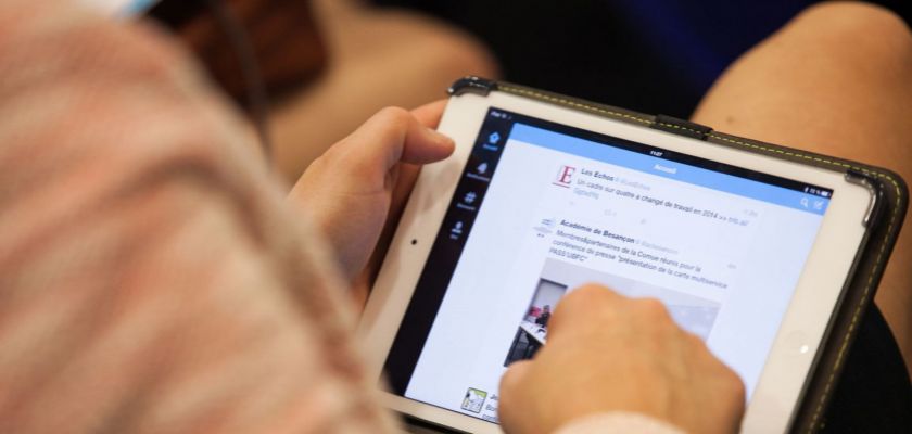 Une personne connectée à Twitter sur sa tablette