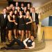 Des étudiants posent en tenue de gala sur un escalier.